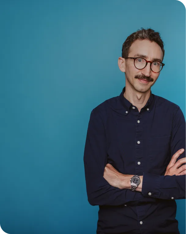 Man smiling with arms crossed