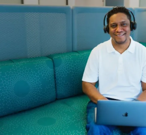 WP Engine Customer Support Representative wearing headphones with a laptop